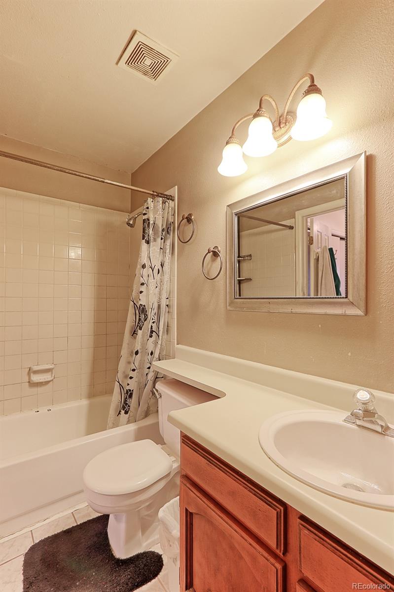 12133 Bannock Circle, Unit B Westminster, CO 80234 - Photo 12 of 14 a bathroom with a sink a toilet and shower