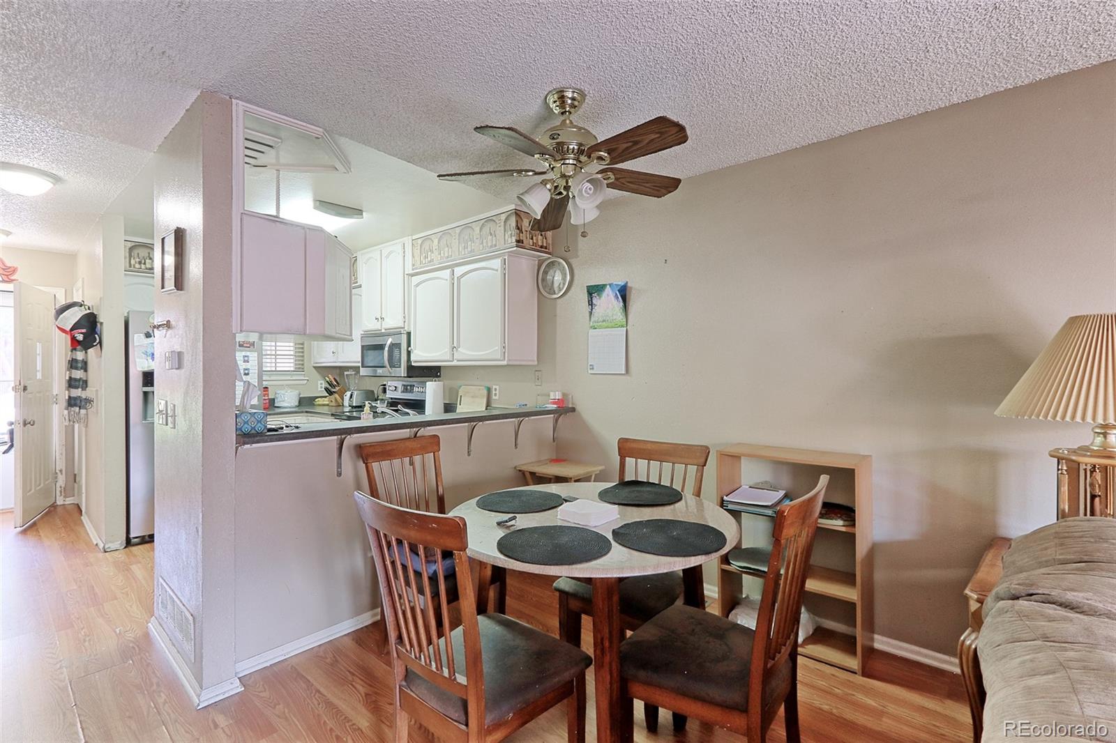 12133 Bannock Circle, Unit B Westminster, CO 80234 - Photo 5 of 14 a view of a dining room with furniture and wooden floor
