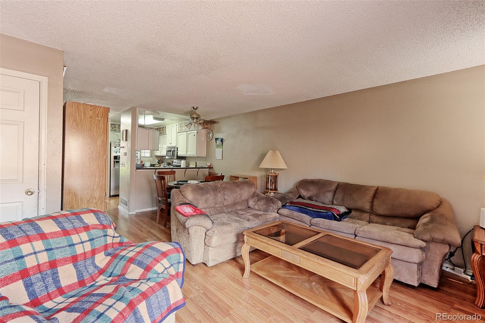 12133 Bannock Circle, Unit B Westminster, CO 80234 - Photo 6 of 14 a bedroom with furniture and a wooden floor