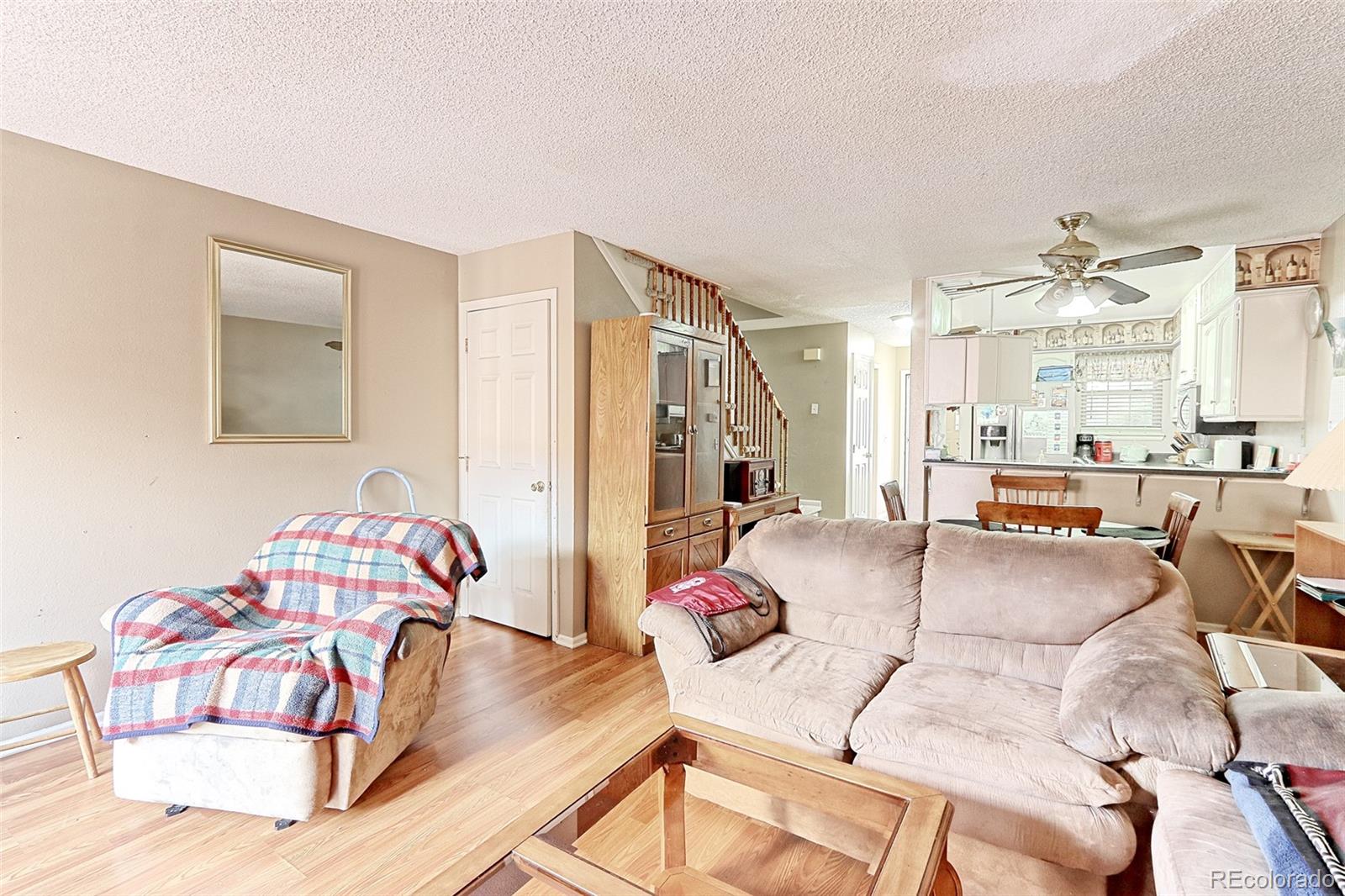 12133 Bannock Circle, Unit B Westminster, CO 80234 - Photo 7 of 14 a living room with furniture and a table