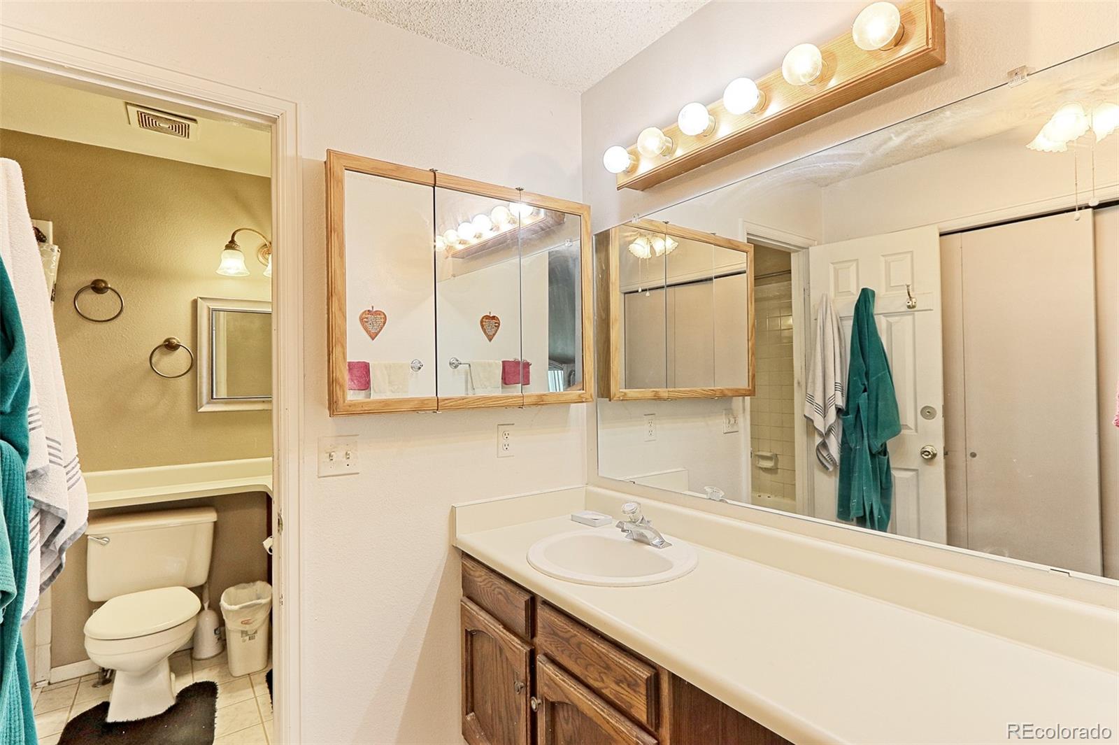 12133 Bannock Circle, Unit B Westminster, CO 80234 - Photo 10 of 14 a bathroom with a sink and a mirror