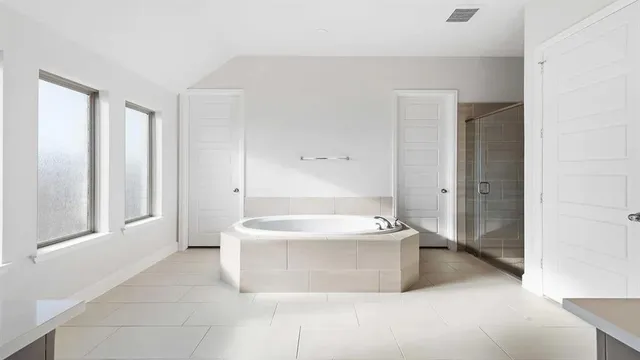 a white bath tub sitting in a spacious bathroom