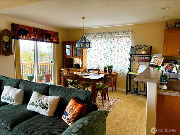 a view of a dining room with furniture and chandelier