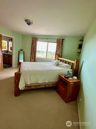 a bedroom with a bed and window