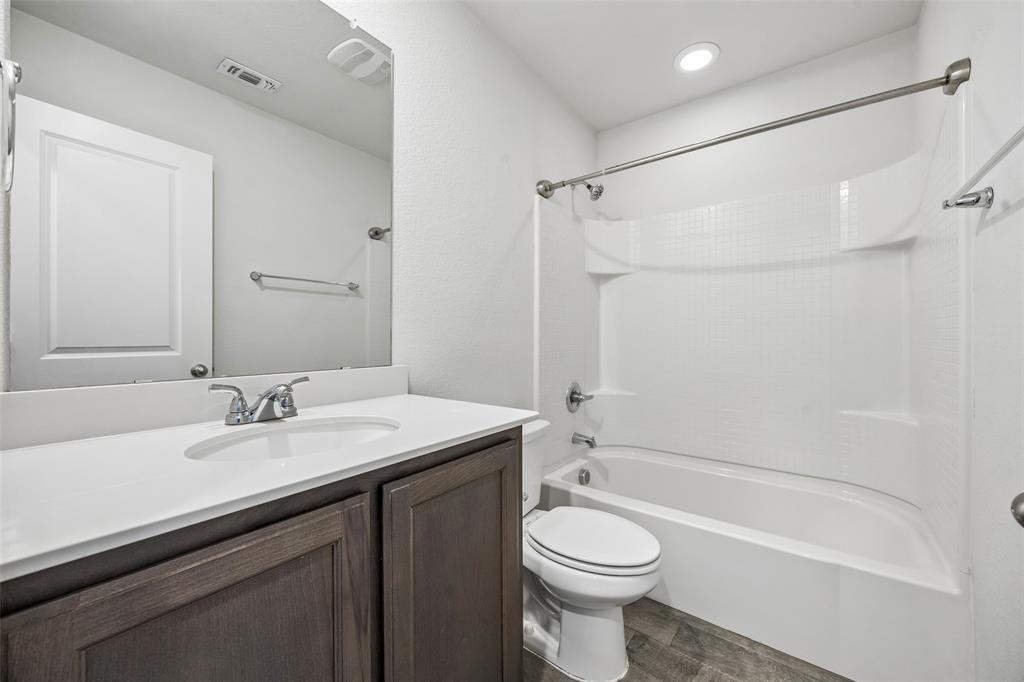 3807 Dogwood Road Melissa, TX 75454 - Photo 32 of 38 a bathroom with a sink a toilet and shower