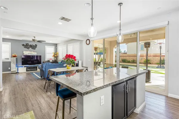 a kitchen with granite countertop a table chairs stove and kitchen view