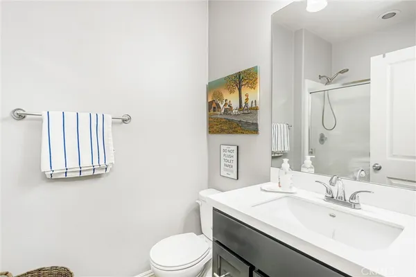 a bathroom with a sink toilet and mirror