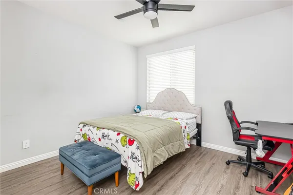 a bedroom with a bed and a wooden floor