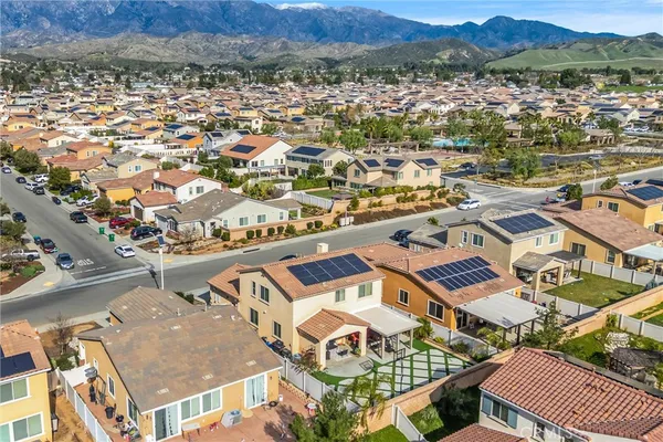 an aerial view of residential houses with outdoor space and trees