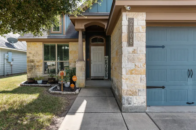 a view of front door of house with outdoor seating