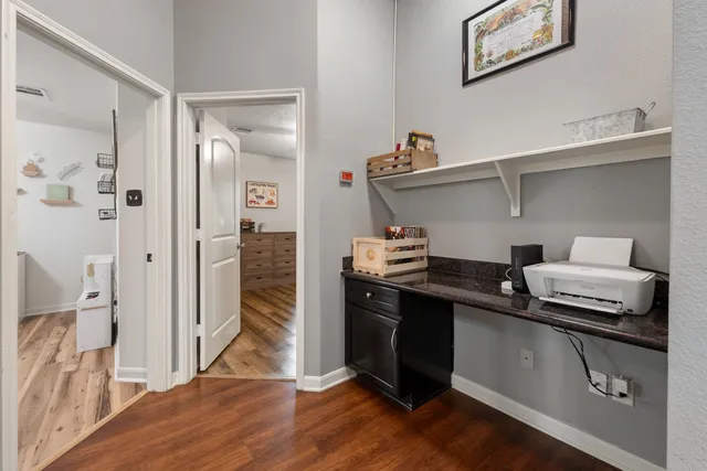 a kitchen with a sink and wooden floor