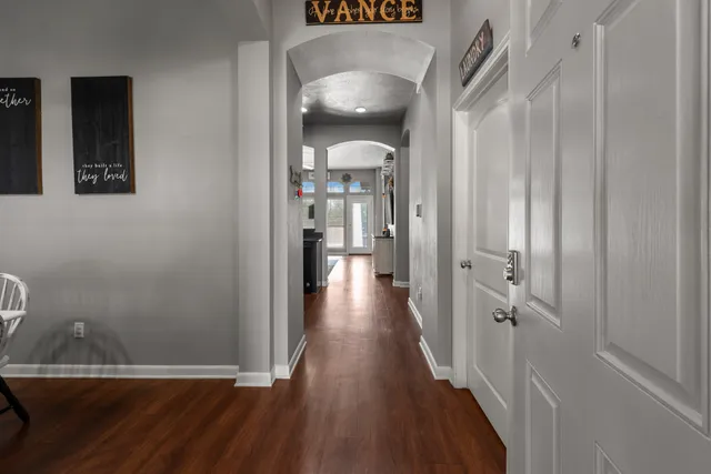 a view of a hallway with wooden floor