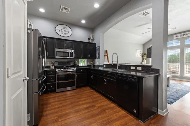 a kitchen with a sink appliances and cabinets
