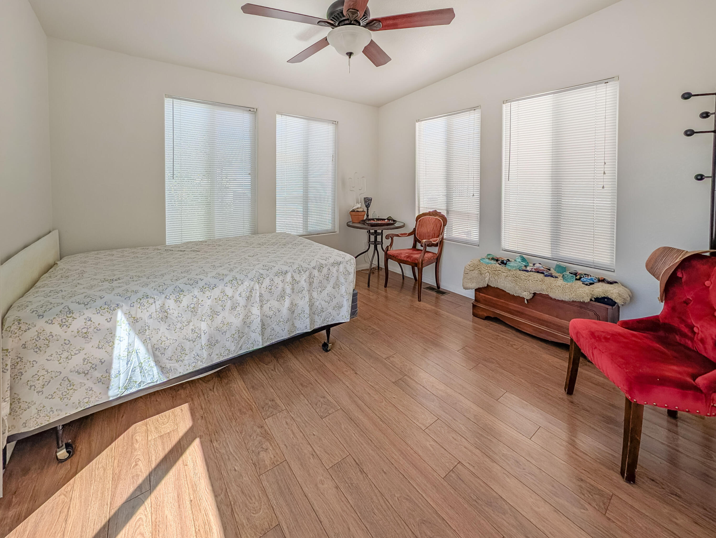 70200 Dillon Road, Unit 169 Desert Hot Springs, CA 92241 - Photo 18 of 25 a spacious bedroom with a bed a couch and a window