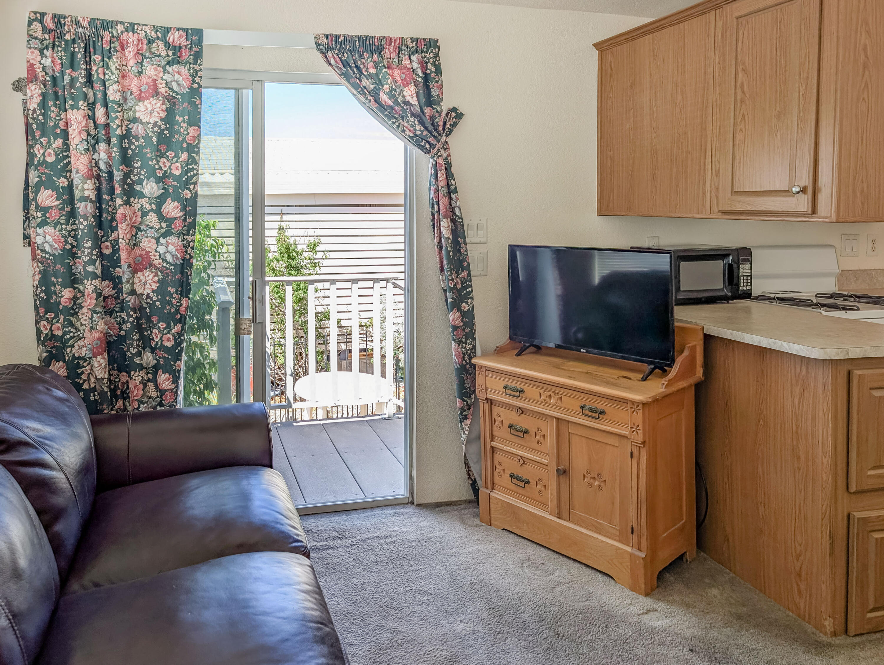 70200 Dillon Road, Unit 169 Desert Hot Springs, CA 92241 - Photo 7 of 25 a living room with furniture and a flat screen tv