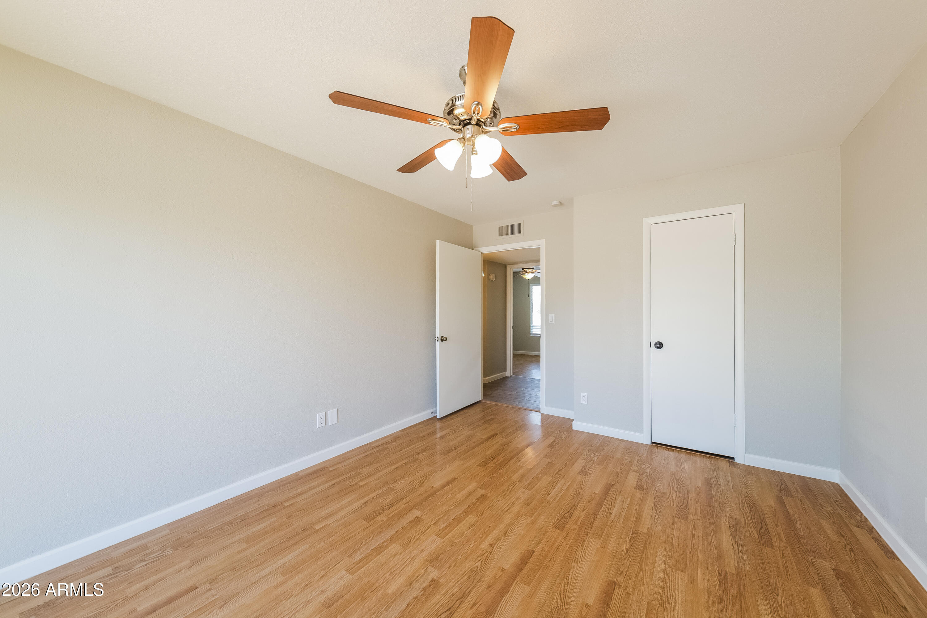 2501 East Villa Rita Drive Phoenix, AZ 85032 - Photo 15 of 15 a view of a big room with wooden floor and a ceiling fan