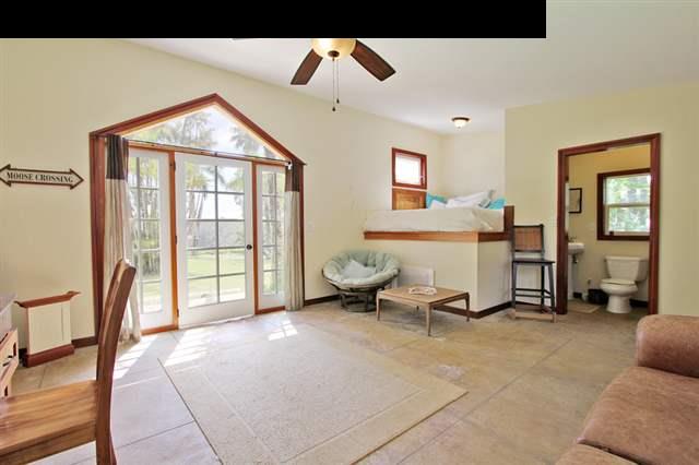 580 Awalau Road Haiku, HI 96708 - Photo 14 of 16 a living room with furniture gym equipment and a large window