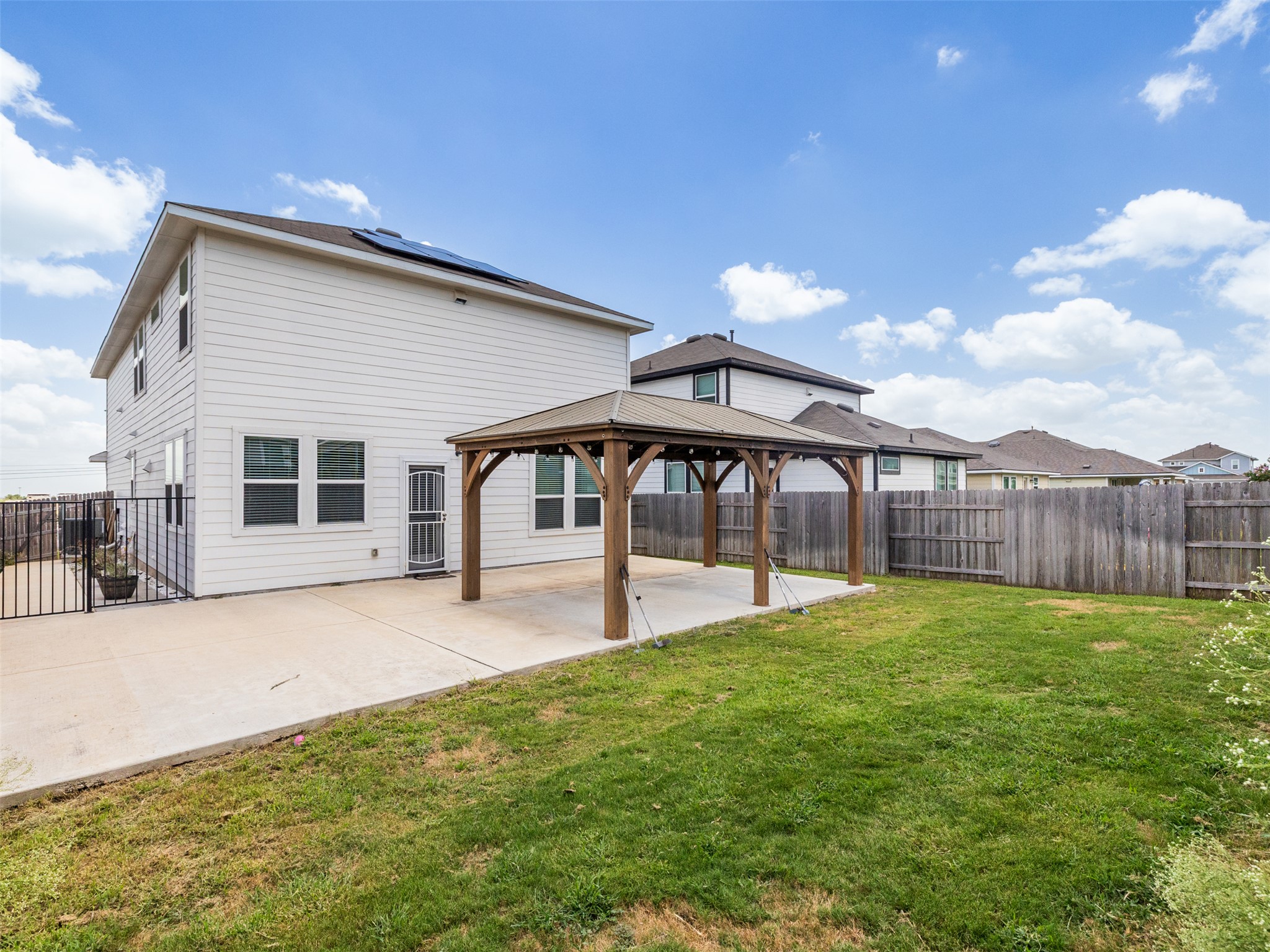 121 Graver Street Georgetown, TX 78626 - Photo 24 of 28 A spacious backyard with a patio and shaded gazebo offers ideal outdoor relaxation.