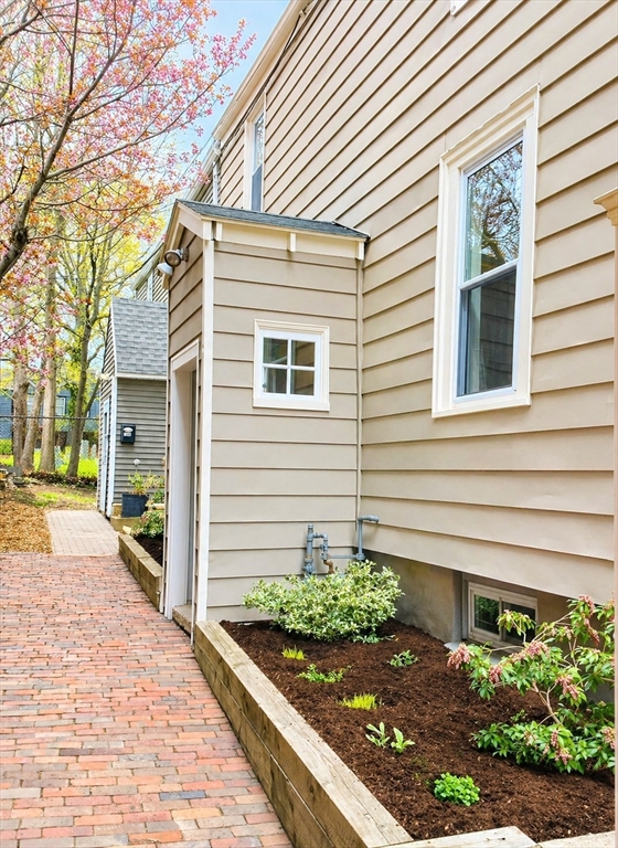 18 R Polk Street Boston, MA 02129 - Photo 19 of 19 a front view of a house with garden