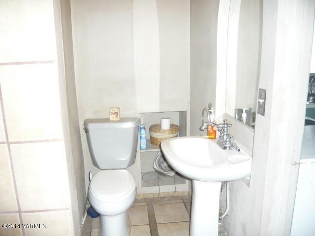 123 Beffa Road Tieton, WA 98947 - Photo 18 of 37 a bathroom with a toilet a sink and a mirror