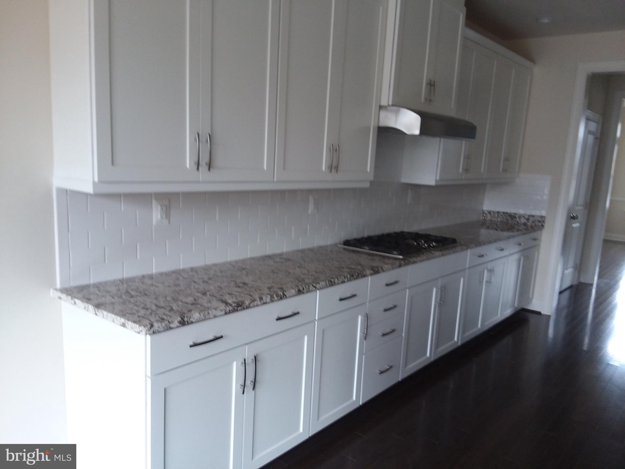 22595 Windsor Locks Square Ashburn, VA 20148 - Photo 12 of 56 a kitchen with granite countertop white cabinets and a stove