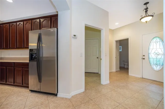 a view of a kitchen with refrigerator and cabinets