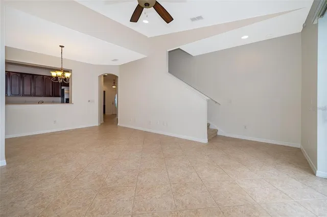 a view of an empty room with kitchen