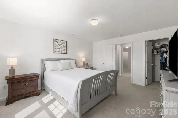 a bedroom with a bed and a television