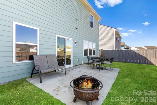 a view of a backyard with sitting area and outdoor seating