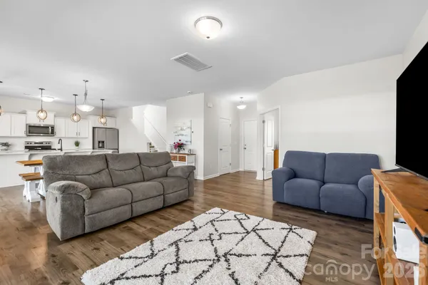 a living room with furniture and kitchen view