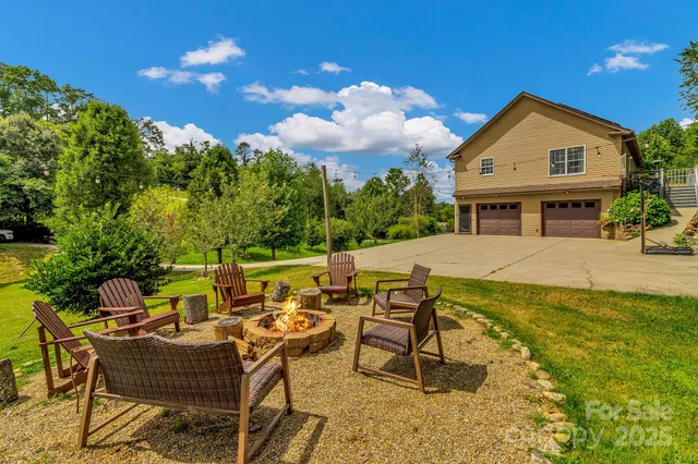 a view of backyard of house with table and chairs