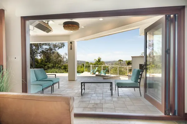 a living room with couches and a coffee table next to a large window