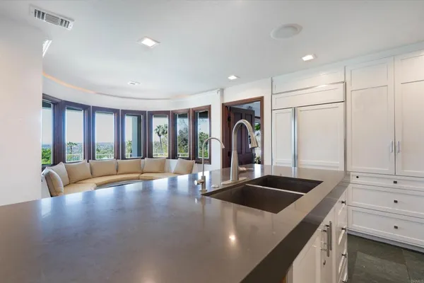 a kitchen with stainless steel appliances granite countertop a sink a stove and a refrigerator with wooden floor