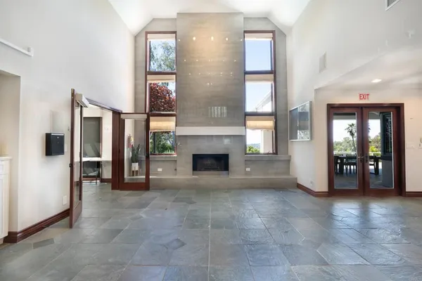 a view of a livingroom with a fireplace and window