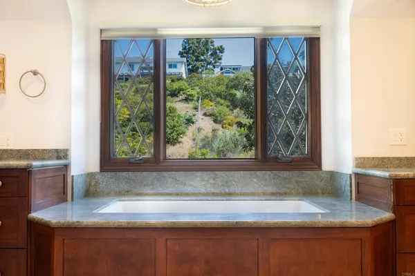 a view of kitchen island a sink microwave and cabinets