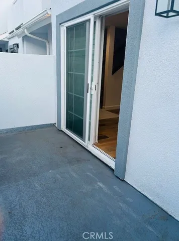 a view of hallway with wooden floor and chandelier