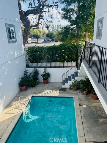 a view of backyard with swimming pool and outdoor seating