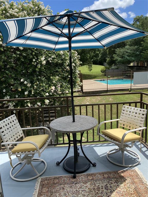 a view of a chairs and table in backyard