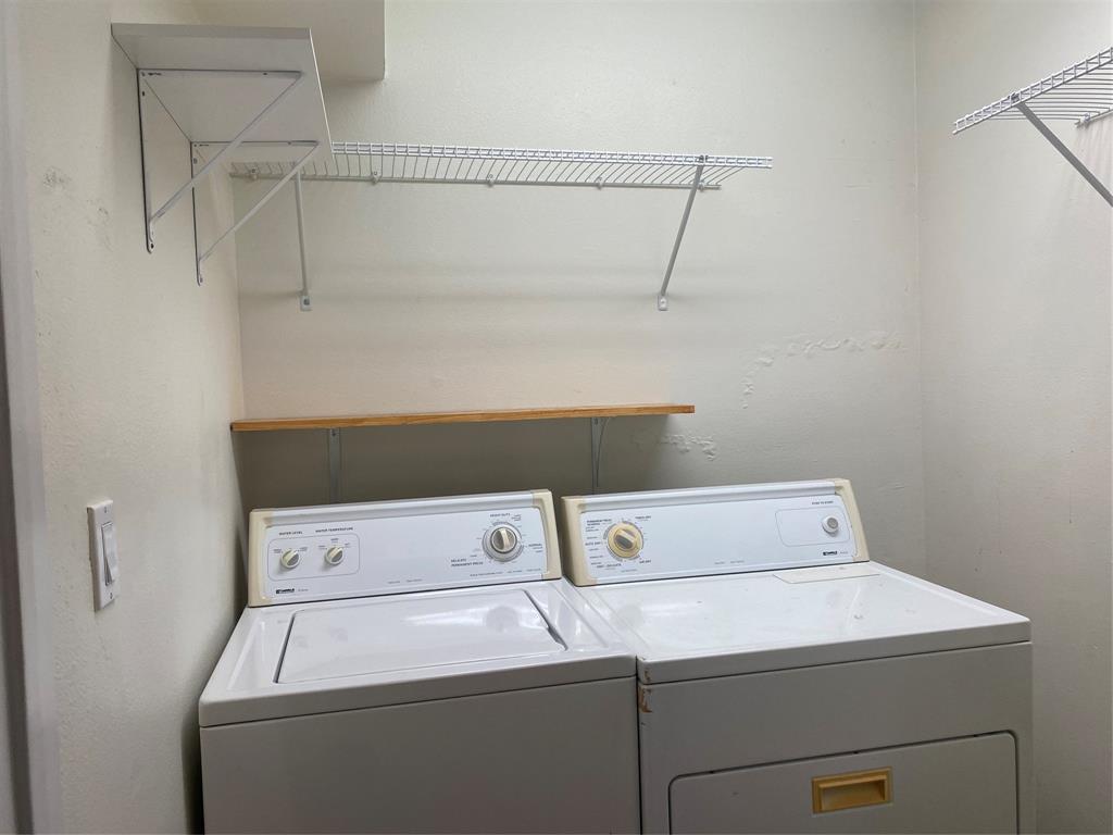 1500 Lake Shore Drive, Unit 213 Waco, TX 76708 - Photo 11 of 21 a close up view of washer and dryer with racks on the wall