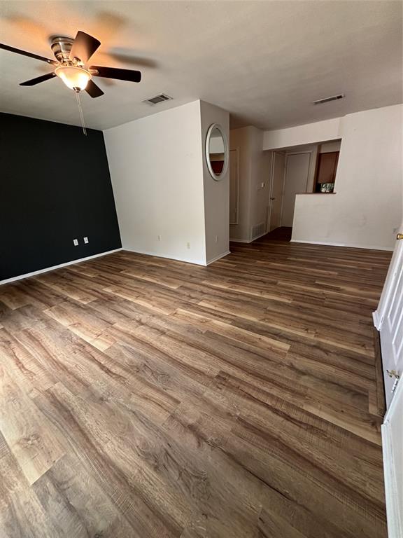 1500 Lake Shore Drive, Unit 213 Waco, TX 76708 - Photo 16 of 21 a view of a room with a ceiling fan and hardwood floor