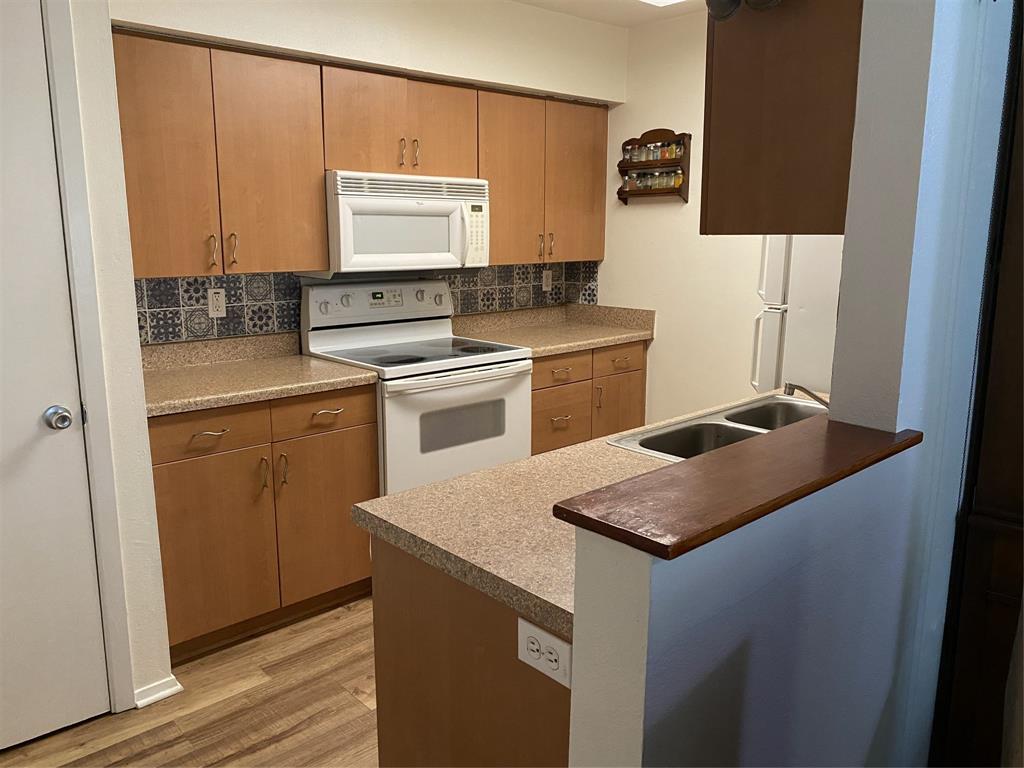 1500 Lake Shore Drive, Unit 213 Waco, TX 76708 - Photo 4 of 21 a kitchen with stainless steel appliances granite countertop a sink stove and refrigerator