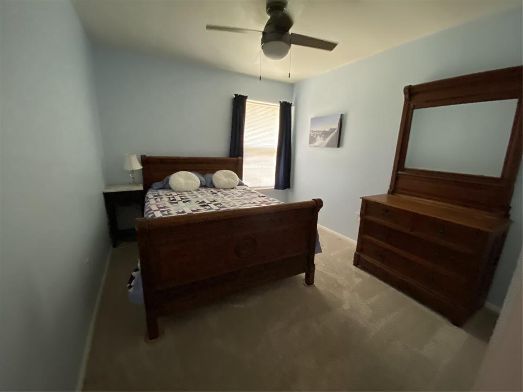 1500 Lake Shore Drive, Unit 213 Waco, TX 76708 - Photo 7 of 21 a bed room with furniture and a window