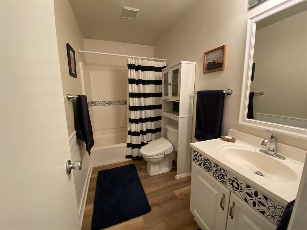 1500 Lake Shore Drive, Unit 213 Waco, TX 76708 - Photo 8 of 21 a bathroom with a sink toilet and shower
