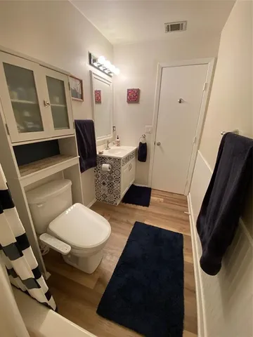 a bathroom with a sink toilet and mirror