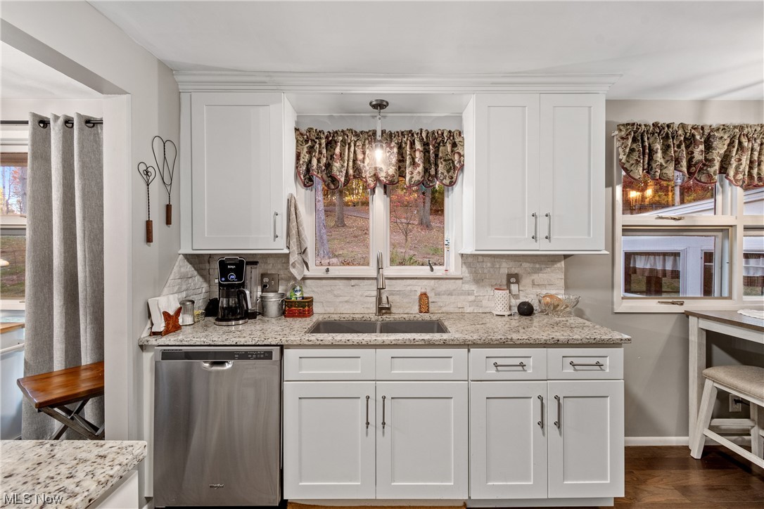 5369 Ridge Avenue Southeast Canton, OH 44707 - Photo 8 of 33 Kitchen with sink, backsplash, dishwasher, and white cabinetry