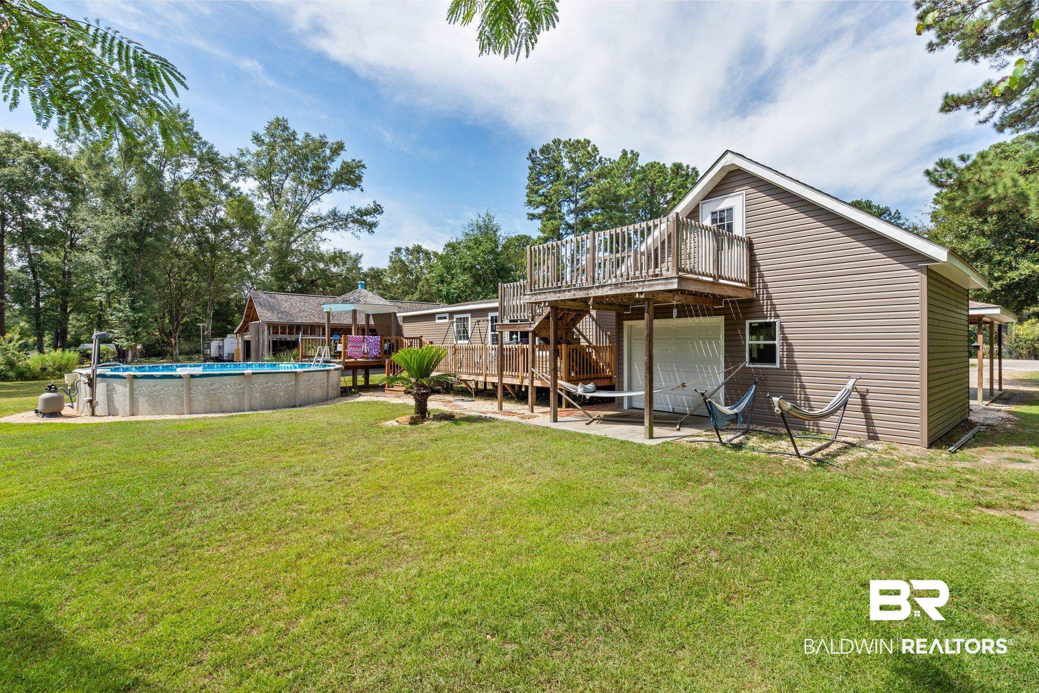 4510 Brannon Road Wilmer, AL 36587 - Photo 4 of 36 Rear view of property with a swimming pool side deck and a yard