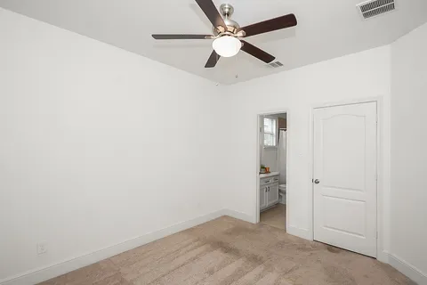 a bathroom with a sink a toilet and a window