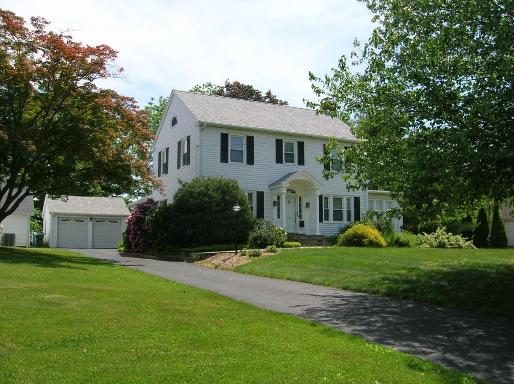 708 Ridge Road Middletown, CT 06457 - Photo 1 of 1 a front view of a house with a garden and trees