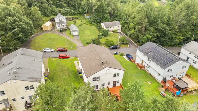 an aerial view of multiple houses with yard