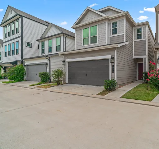 a front view of a house with a yard and a garage